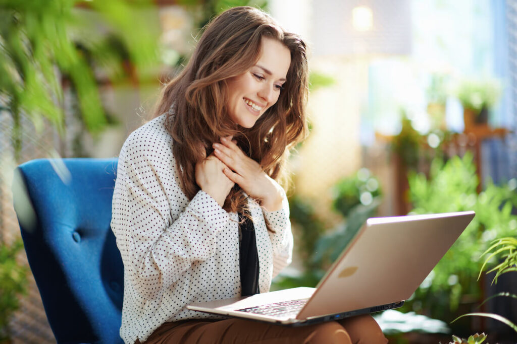 Happy woman using a laptop