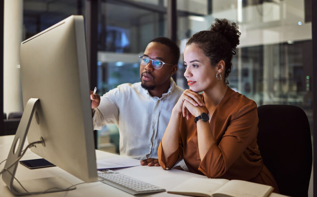 Health information technology: employees looking at a desktop computer